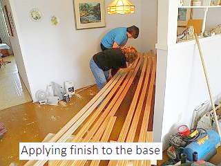 Photo of applying finish to the base of laminate flooring.
