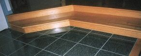 Photo of hardwood steps in front of a hearth.